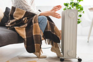 image of homeowner using space heater