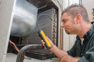HVAC contractor detecting refrigerant leaks