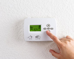 image of Raritan NJ homeowner with programmable thermostat 