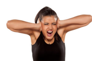 image of a woman covering her ears due to banging water pipes