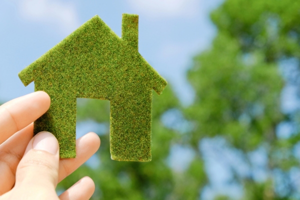 green miniature house cutout depicting eco friendly Furnace Filters