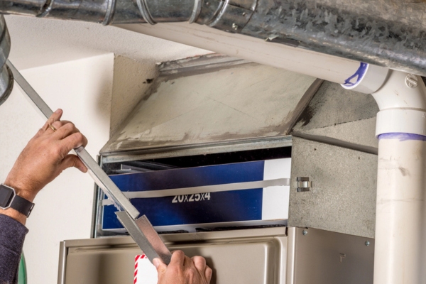 homeowner about to change furnace filter