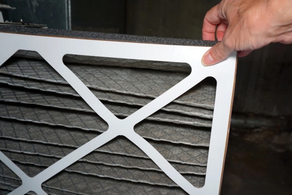 homeowner removing dirty HVAC filter