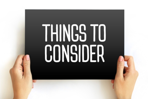things to consider sign held by a woman's hand depicting Choosing Between Single-Zone & Multi-Zone Ductless