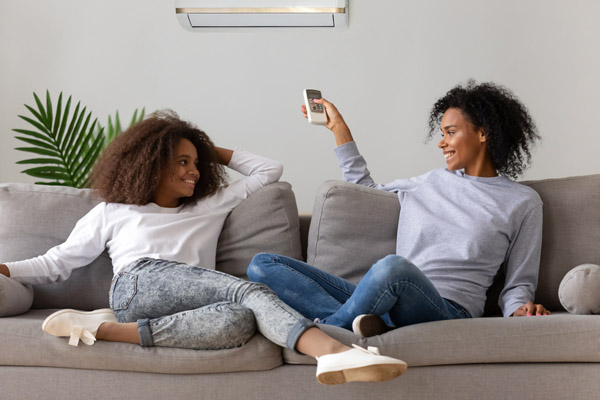 image of family indoors in front of a ductless indoor unit