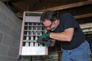 image of an hvac contractor performing furnace repair