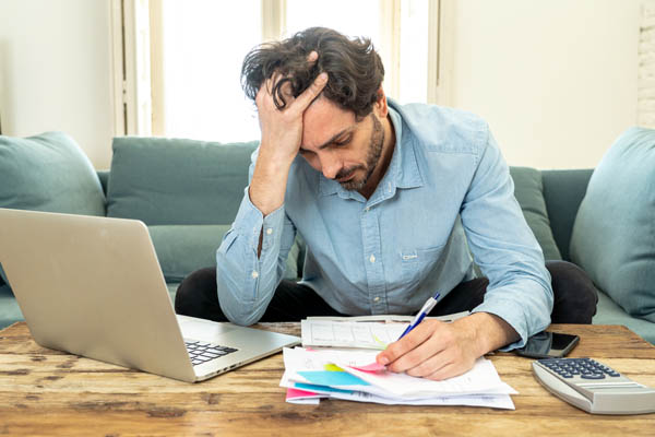 man looking at expensive home heating bill