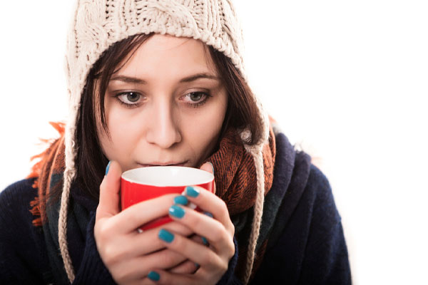 woman feeling cold due to poor furnace heating