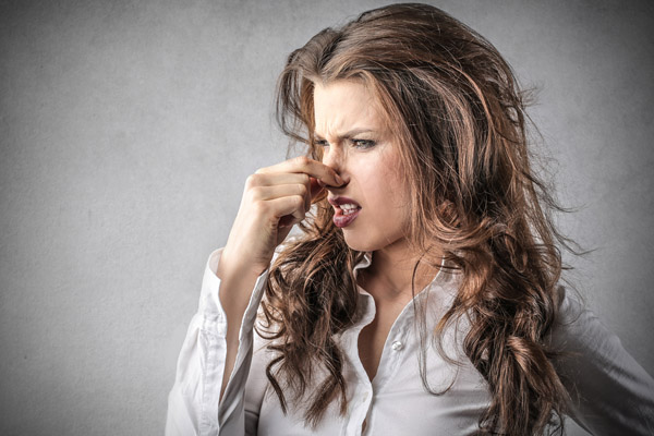 image of a homeowner noticing a bad odor from furnace