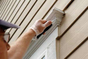 image of homeowner sealing air drafts