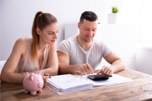 image of couple calculating savings after air conditioner upgrade