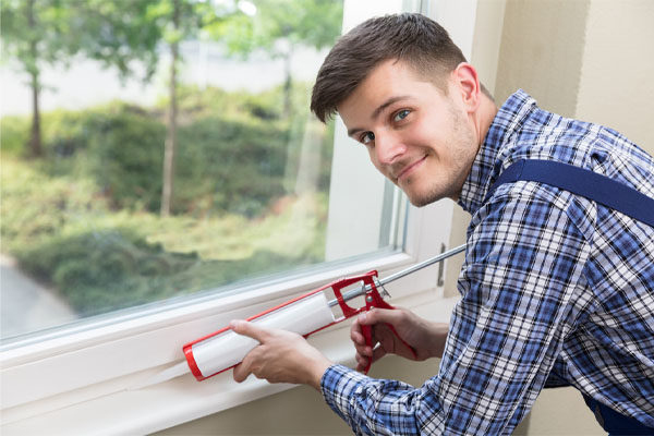 image of an hvac contractor sealing air leaks in a home