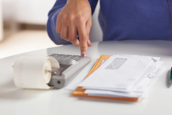 image of hand and calculator depicting home cooling costs