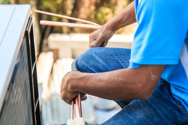 image of an hvac contractor performing air conditioner installation