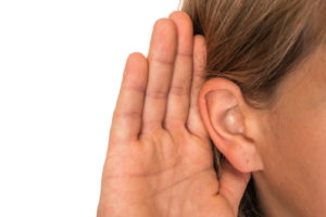 image of a homeowner holding ear and listening to whistle from oil delivery