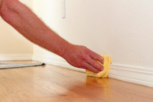 image of homeowner removing dust from home to improve indoor air quality