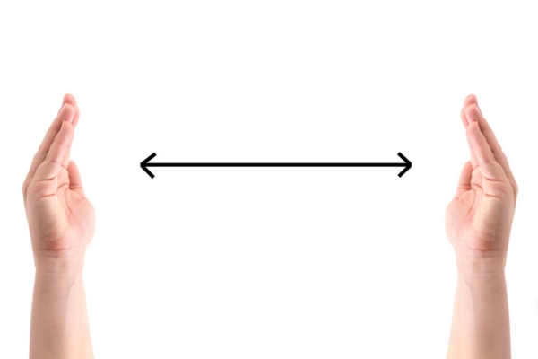 hands with double sided doodle linear arrow in between depicting how to size a standby generator