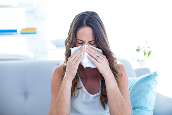 image of homeowner with allergies due to air conditionting unit mold