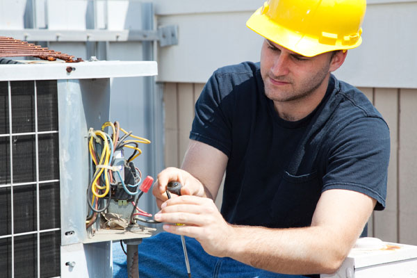 image of an hvac contractor performing an air conditioner tune-up
