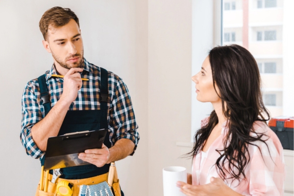 generator maintenance professional talking to a homeowner after doing load testing
