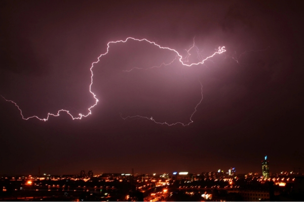 thunderbolt over cityscape depicting power interruption