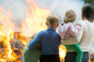 image of a family in front of a burning raritan nj house depicting a natural gas leak