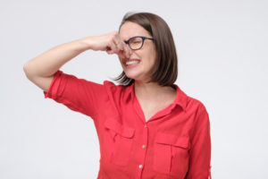 woman plugging nose due to smelly furnace and natural gas leak