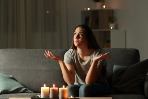 image of a homeowner during a power outage who requires a new backup generator