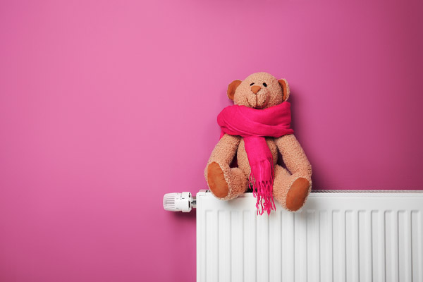 image of a teddy bear on radiator depicting home heating oil