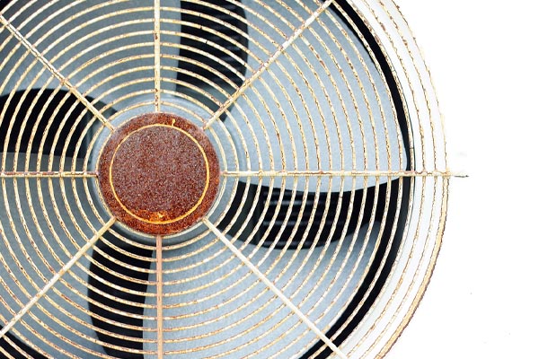 image of a fan on air conditioner condenser that is rusty