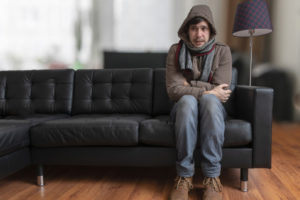 image of a homeowner feeling chilly due to boiler problems