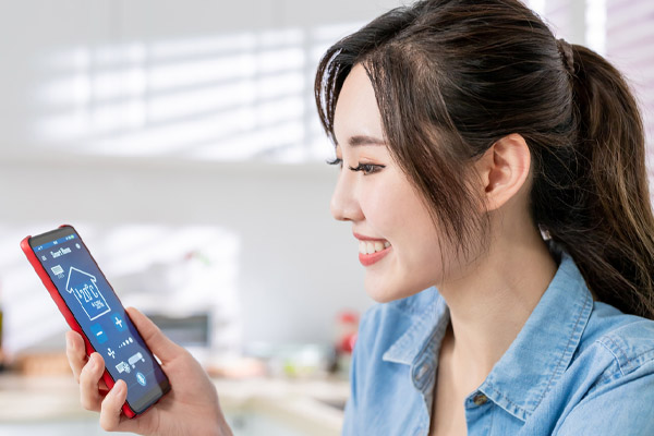 image of a homeowner using phone to control home heating system remotely