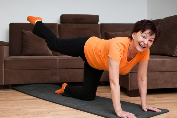 image of a homeowner exercising at home to stay warm while waiting for emergency heating repair service
