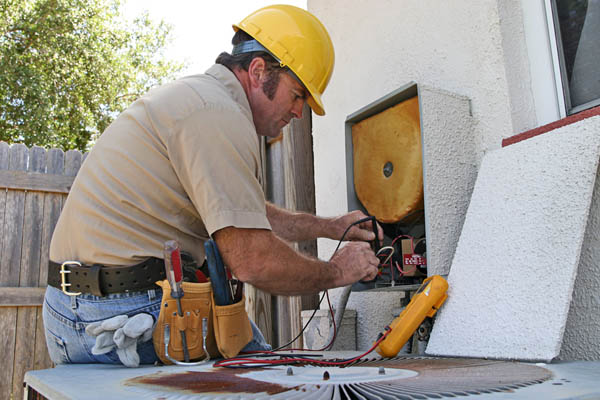 image of an hvac contractor performing an air conditioner tune-up