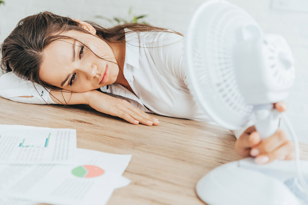 image of a homeowner feeling hot and uncomfortable due to summer heat and air conditioner costs