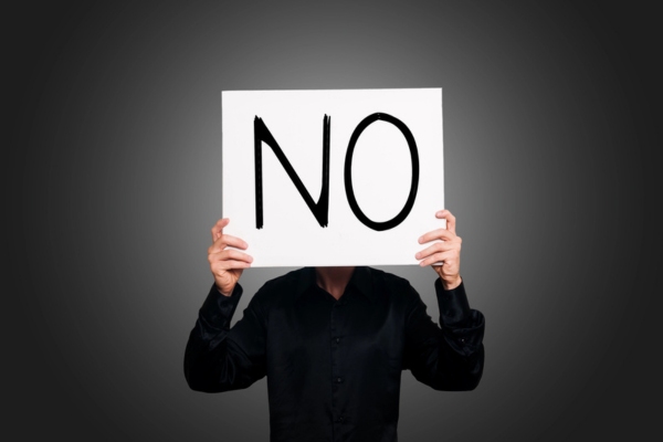 man holding no sign in front of his face depicting DIY air conditioner maintenance and diy ac repair