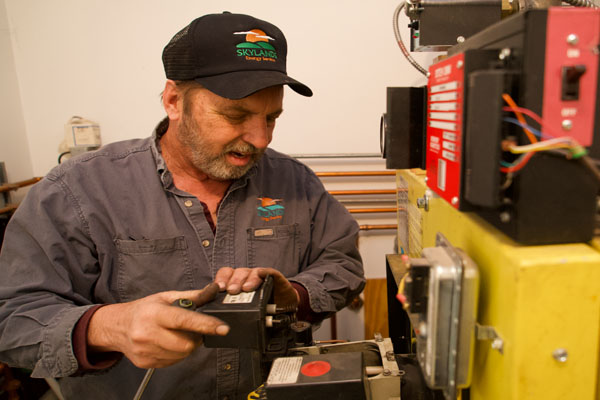 image of an hvac technician maintaining a boiler