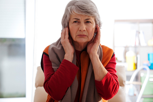 image of woman covering ears due to loud hvac noise
