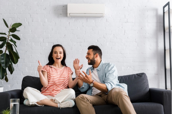 couple celebrating and doing a thumbs up depicting helping air conditioner last longer due to tune-up