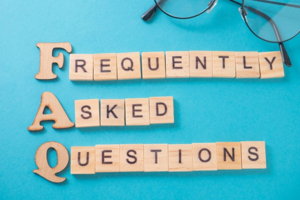 FREQUENTLY ASKED QUESTIONS spelled using wooden letters depicting Energy-Efficient Air Conditioners FAQs