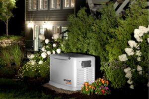 well lit house with whole house backup generator outside depicting automatic activation during a power outage