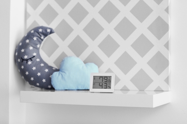 hygrometer showing indoor humidity and temperature beside display pillows depicting enhanced comfort