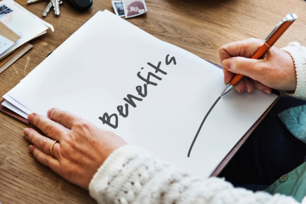 woman writing benefits on a paper depicting dehumidifier