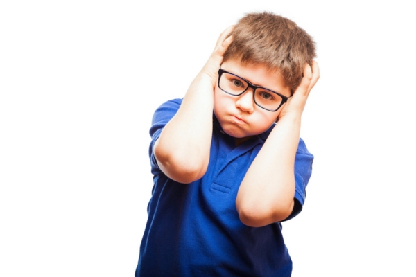 young boy covering his ears depicting air conditioner noise