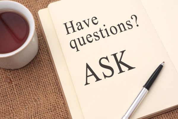 Have questions, ask written on a notebook depicting FAQs about AC replace or repair