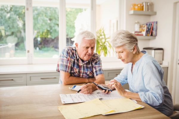 senior couple computing monthly energy costs