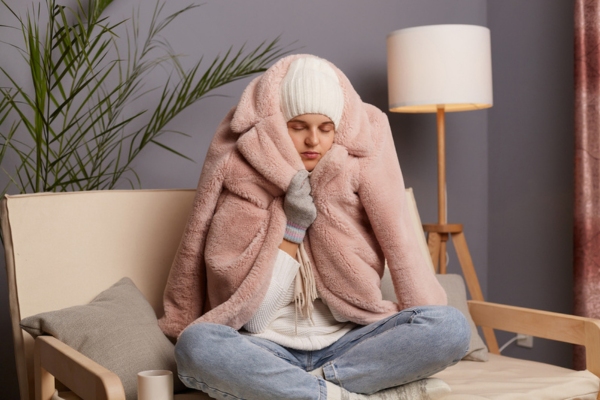 woman feeling cold indoors due to uneven room temperature