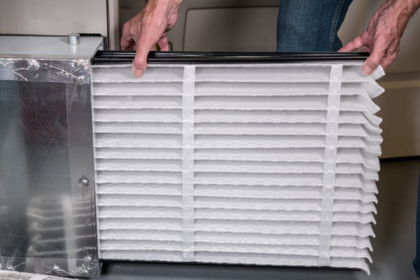 homeowner inserting a new HVAC filter