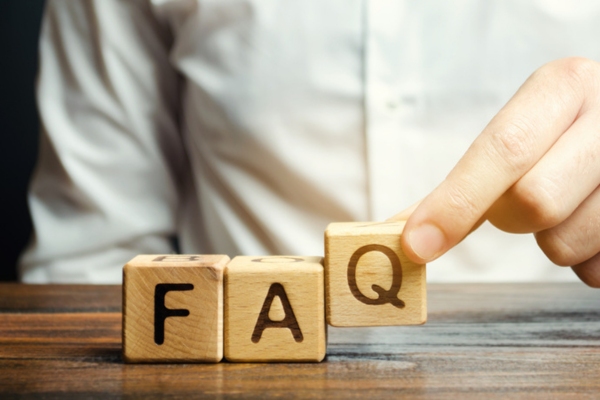 man completing the acronym FAQ with wooden letter cubes depicting questions about HVAC Air Filter Replacement