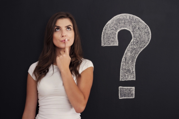 thinking Woman with question mark on blackboard depicting FAQs about Furnace Reset Button